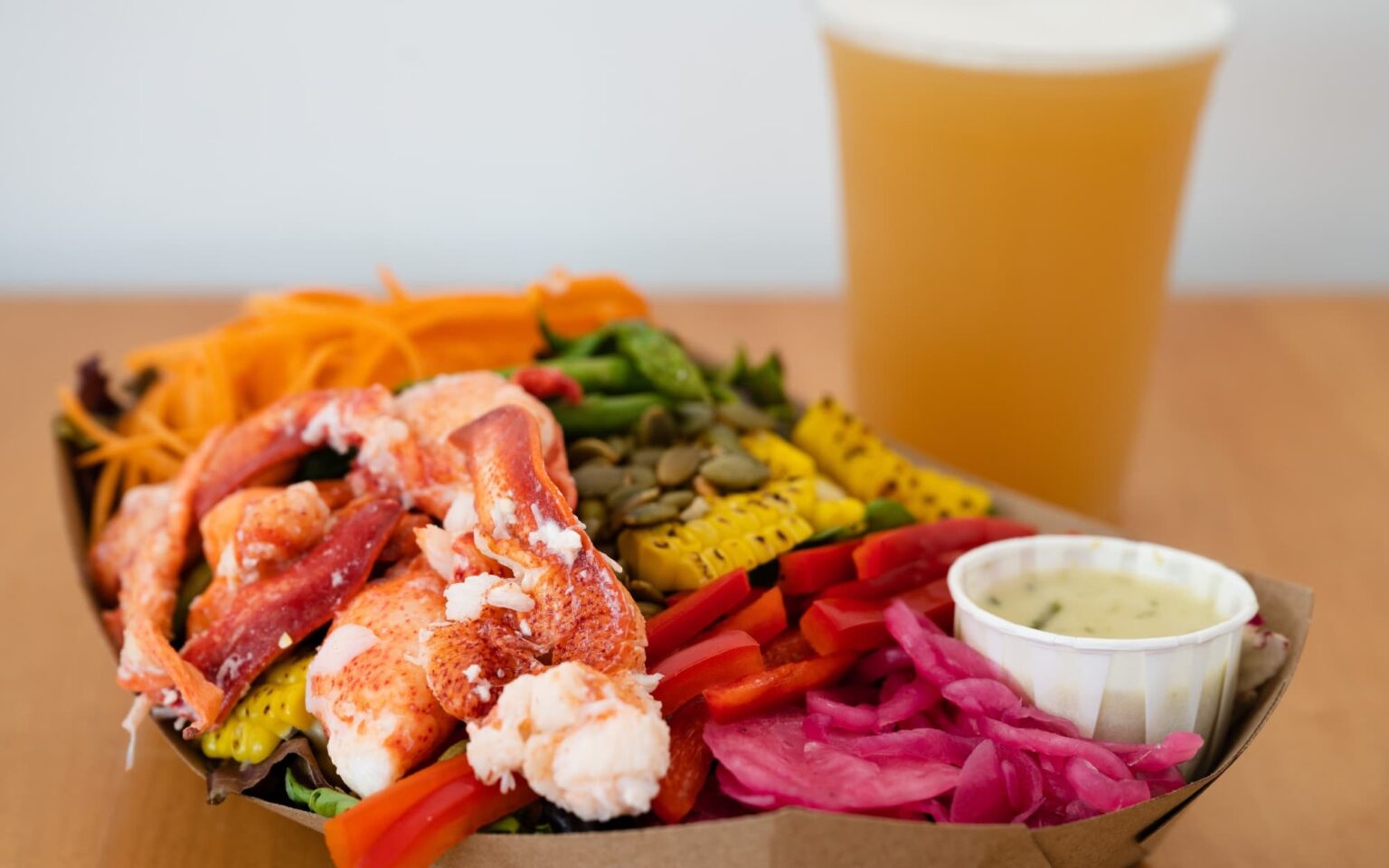 The Buoy Shack salad shown topped with a healthy portion of Maine lobster.